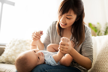 Image showing happy young mother with little baby son at home