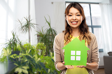 Image showing happy asian woman with green house at home