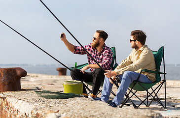 Image showing friends fishing and taking selfie by smartphone