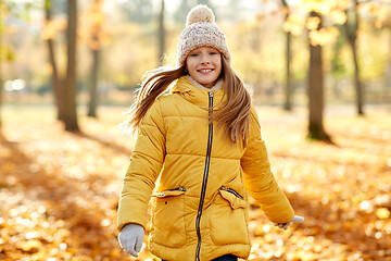 Image showing happy girl walking at autumn park