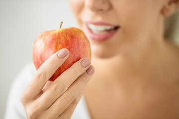 Image showing close up of woman holding ripe red apple