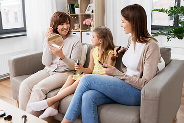 Image showing mother, daughter and grandmother doing make up