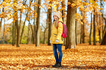 Image showing happy student girl with schoolbag at autumn park