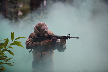 Image showing soldier in action aiming  on weapon  laser sight optics