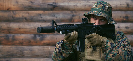 Image showing soldier in action aiming  on weapon  laser sight optics