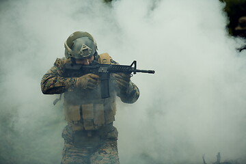 Image showing soldier in action aiming  on weapon  laser sight optics