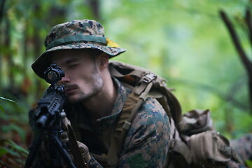 Image showing soldier in action aiming  on weapon  laser sight optics