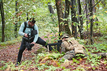 Image showing Videographer Taking Action Shoot of Soldiers in Action