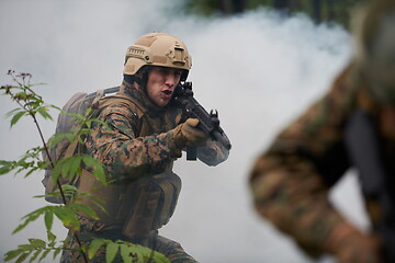 Image showing soldier in action aiming  on weapon  laser sight optics