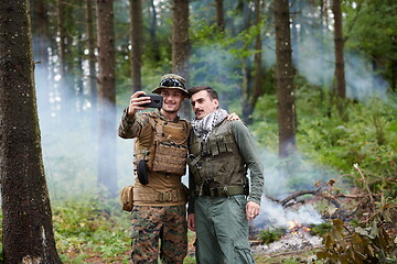 Image showing soldiers and terrorist taking selfie