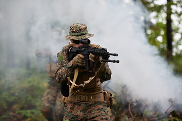Image showing soldier in action aiming  on weapon  laser sight optics