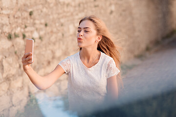 Image showing Girl take selfie from hands with phone on summer city
