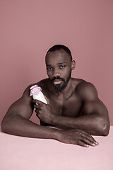 Image showing Healthy young african man holging milk