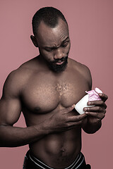 Image showing Healthy young african man holging milk