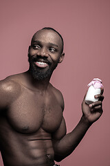 Image showing Healthy young african man holging milk