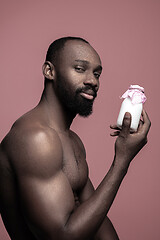 Image showing Healthy young african man holging milk