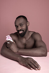 Image showing Healthy young african man holging milk