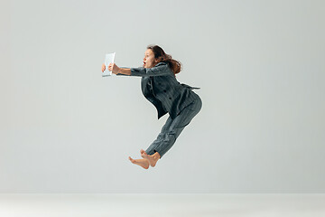 Image showing Happy business woman dancing and smiling isolated over white.