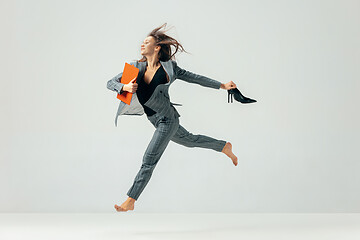 Image showing Happy business woman dancing and smiling isolated over white.