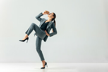 Image showing Happy business woman dancing and smiling isolated over white.