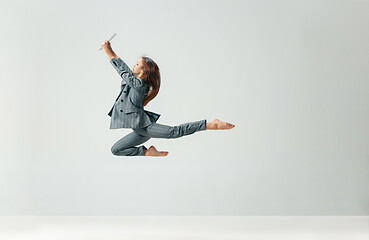 Image showing Happy business woman dancing and smiling isolated over white.