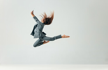 Image showing Happy business woman dancing and smiling isolated over white.