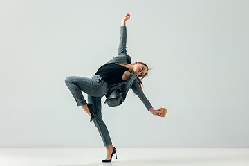 Image showing Happy business woman dancing and smiling isolated over white.