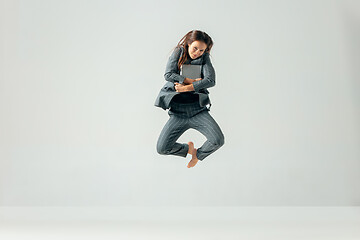 Image showing Happy business woman dancing and smiling isolated over white.