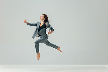 Image showing Happy business woman dancing and smiling isolated over white.