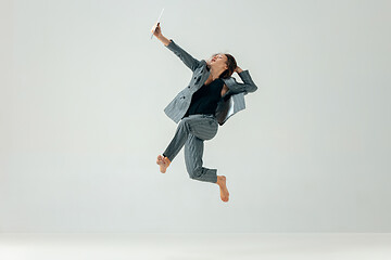 Image showing Happy business woman dancing and smiling isolated over white.