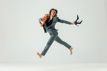 Image showing Happy business woman dancing and smiling isolated over white.