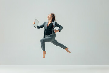 Image showing Happy business woman dancing and smiling isolated over white.