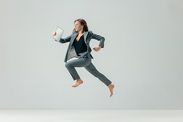 Image showing Happy business woman dancing and smiling isolated over white.