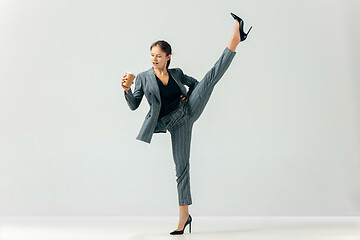 Image showing Happy business woman dancing and smiling isolated over white.