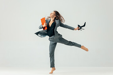 Image showing Happy business woman dancing and smiling isolated over white.