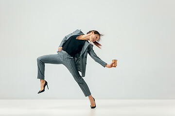 Image showing Happy business woman dancing and smiling isolated over white.