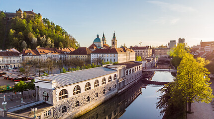 Image showing Aerial drone panoramic view of Ljubljana medieval city center, capital of Slovenia in warm afternoon sun. Empty streets during corona virus pandemic social distancing measures