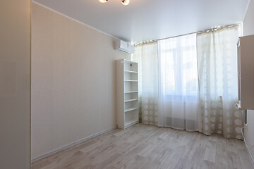 Image showing Fragment of the interior of the room, wardrobe, window, in the middle an empty place for a bed