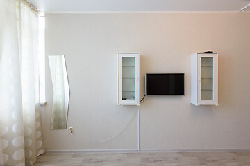 Image showing Fragment of the wall by the window in the bedroom interior, TV and wall cabinets