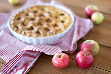 Image showing apple pie in baking mold on wooden table