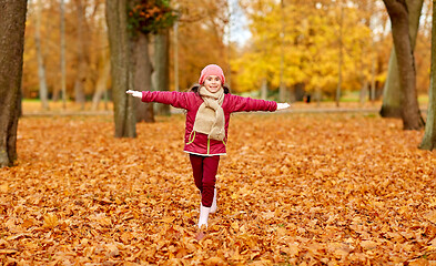 Image showing happy girl running at autumn park