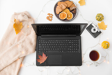 Image showing laptop, tea, camera, autumn leaves and sweater