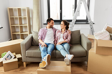 Image showing happy couple with boxes moving to new home