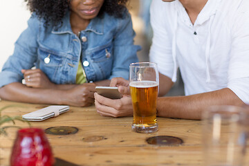 Image showing couple with smartphone and beer at bar
