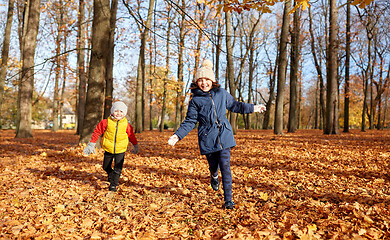 Image showing happy children running at autumn park