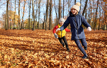 Image showing happy children running at autumn park