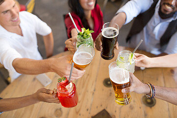 Image showing friends clinking glasses at bar or restaurant