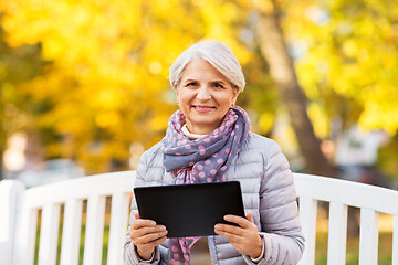 Image showing senior woman with tablet pc at summer park