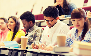 Image showing group of students with coffee writing on lecture