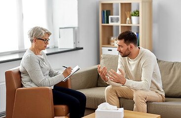 Image showing senior woman psychologist and sad man patient